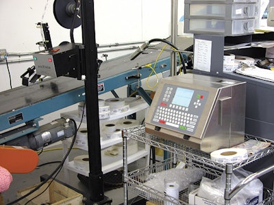 Top photo shows the p-s labeler that applies bar codes; the new ink-jet coder sits a few feet downstream.