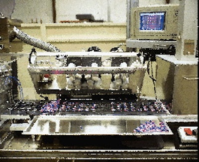 The brush box feeder (far left), shown lifted off the web, uses a series of brushes to distribute tablets into cavities. Interna