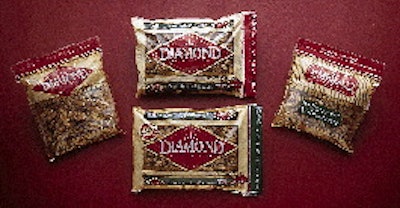 Two reciprocating fill funnels deliver walnuts to open bags, two at a time (above). Downstream, bags are picked up by robotic he