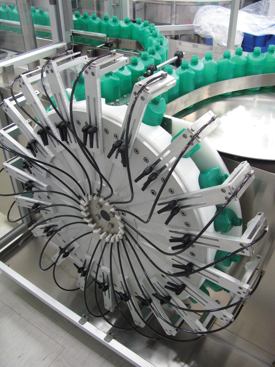 Shortly after HDPE bottles have been unscrambled and oriented on Doppel&rsquo;s new liquids line, the bottles are inverted and cleaned with a burst of purified air.
