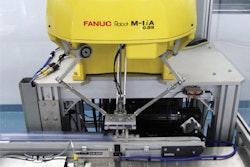 This photo shows a high-speed delta robot that uses a vacuum end-of-arm tool to pick up individual diagnostic test kits and feed them to a flow wrapper.
