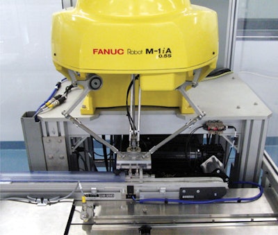 This photo shows a high-speed delta robot that uses a vacuum end-of-arm tool to pick up individual diagnostic test kits and feed them to a flow wrapper.