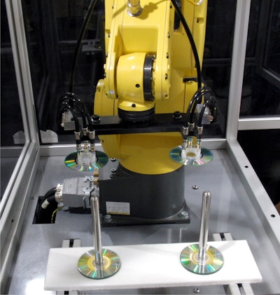 Loading system integrated with rotary-type blister sealer to create automatic blister loading and sealing.