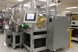 The front of the AFTCATS robotic bottling system shows the main touchscreen display, with the pick-and-place loading robot shown in the window.