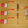 Schreiner-Medipharm's Needle-Trap. It’s a pressure-sensitive label solution for syringes that addresses the problem of sharps. Included here is a photo of (from left to right) three labels still on their release liner, a freshly labeled syringe with its protective needle sheath in place, and a post-injection syringe with its needle safely trapped in plastic with no opportunity whatsoever for harm to healthcare personnel. All that’s left is disposal into the nearest sharps container. According to Schreiner M