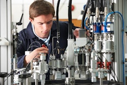 In this photo, an engineer works on complex machinery. Manufacturing’s resurgence creates demand for skilled technicians