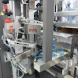 INBOUND CARTONS. As cartons visible in the lower right corner are conveyed into a case packer, a camera reads all 100 unique car