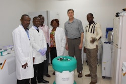 Geoffrey Glauser poses with officials from the College of Medical and Health Sciences and an Arktek container.