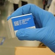 PCI’s Ray Hook holds this example of how laser ablation is applied to solid colors (blue in this instance) on a carton.
