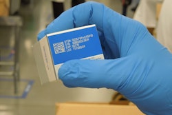 PCI’s Ray Hook holds this example of how laser ablation is applied to solid colors (blue in this instance) on a carton.