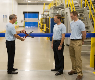 Oliver-Tolas President & CEO Jerry Bennish cuts the ceremonial ribbon while project team members Phil Kaufman and Trent Nobach look on.