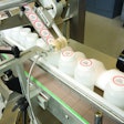 Labels are applied inline to filled and capped plastic bottles at Promega.