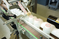 Labels are applied inline to filled and capped plastic bottles at Promega.
