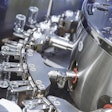 In this photo for illustrative purposes only, a pharmaceutical machine handles glass bottles.