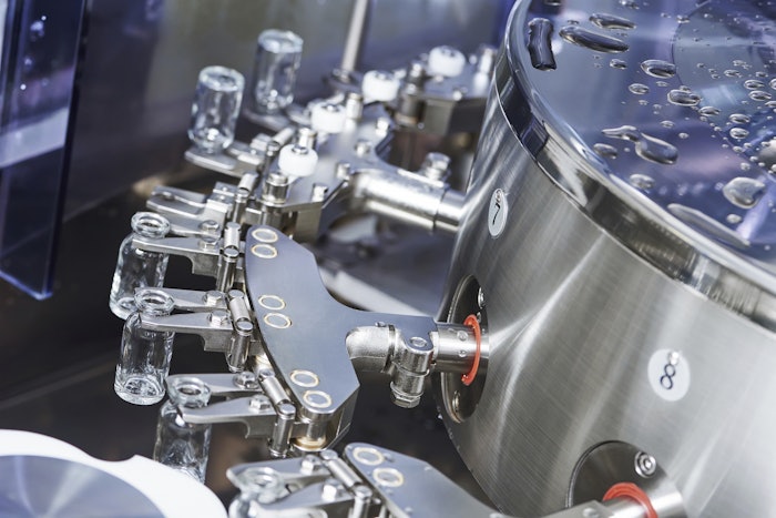 In this photo for illustrative purposes only, a pharmaceutical machine handles glass bottles.