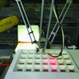 During tray filling, pills are dispensed by a robot through a grid that uses laser beams to verify correct pill placement.
