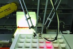 During tray filling, pills are dispensed by a robot through a grid that uses laser beams to verify correct pill placement.