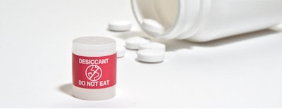 Red labels help differentiate desiccant from the drug product; only FDA- and EU-compliant materials are used.