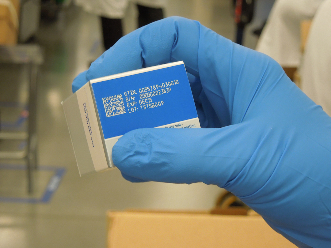 PCI&rsquo;s Ray Hook holds this example of how laser ablation is applied to solid colors (blue in this instance) on a carton.