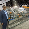 Sabri Demirel, Ulhmann Packaging Systems LP, stands next to refurbished equipment at the Uhlmann booth.