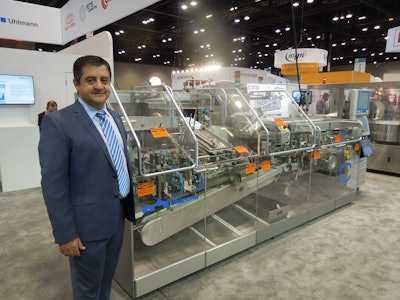 Sabri Demirel, Ulhmann Packaging Systems LP, stands next to refurbished equipment at the Uhlmann booth.