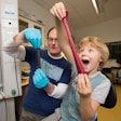 Coleman and his son play with his new invention. / Photo: Trinity College Dublin