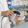 This image shows a healthcare professional scanning a barcode.