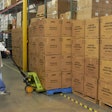 An employee moves a pallet of empty boxes in preparation for shipment at a Pelican BioThermal service center.