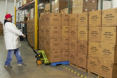 An employee moves a pallet of empty boxes in preparation for shipment at a Pelican BioThermal service center.