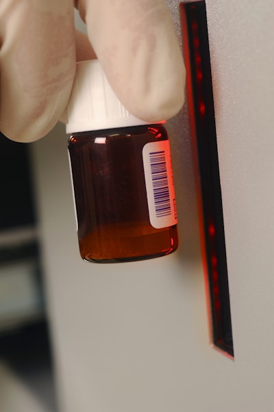 Shown here is a TEKLYNX vial scanner in use.