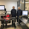 Afton Scientific’s Kari Moore (left) and Ashley Umberger stand beside the packaging line where the serialization equipment is seen on the conveyor, with the aggregation equipment on the tabletop.