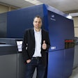 Arndt Eschenlohr, President of PLS Print Logistic Services GmbH, next to the digital sheet-fed press.
