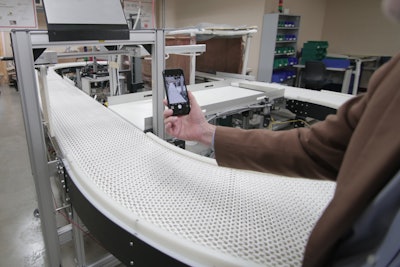 Rob Radwin positions a smartphone to record video of a conveyor belt — a better method for measuring the risk presented by repetitive workplace tasks and safeguard workers against injury. Photo: Stephanie Precourt/UW–Madison