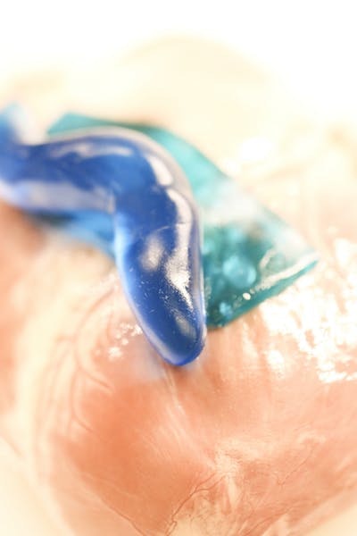 A new, flexible adhesive material inspired by the glue secreted by slugs adheres to biological tissues (even when wet) without causing toxicity, and can be formed into either sheets (teal blue) or custom shapes (dark blue). Credit: Wyss Institute at Harvard University