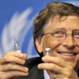 Bill Gates holding a vaccine. / Image: The Guardian