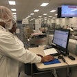 Sovensky Preston (front) and Janice Jackson (rear) analyze OEE data on Packaging Line 2 at Pharmavite in Opelika, Alabama.
