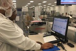 Sovensky Preston (front) and Janice Jackson (rear) analyze OEE data on Packaging Line 2 at Pharmavite in Opelika, Alabama.