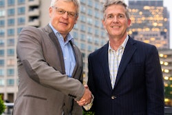 Dr. Andreas Fischer, Werum IT Solutions, and Charles Mooney, Blood Centers of America, closing the agreement.