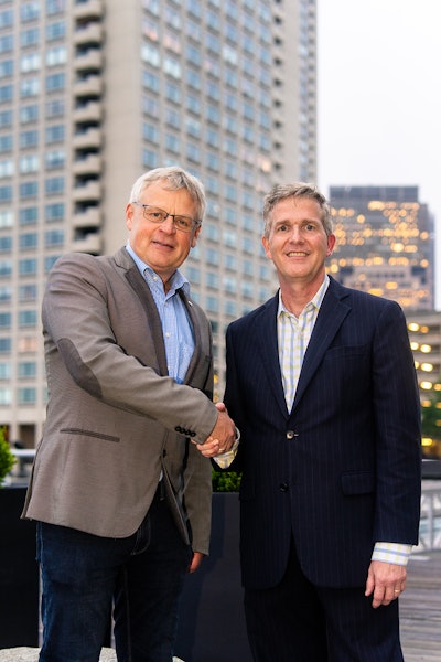 Dr. Andreas Fischer, Werum IT Solutions, and Charles Mooney, Blood Centers of America, closing the agreement.