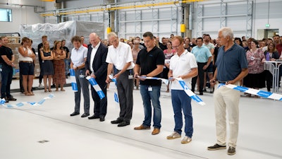 On the occasion of the inauguration of the new assembly hall, Annette Walser-Schaeff (Production Manager, OPTIMA pharma GmbH), Gerhard Breu (Chairman, Optima Pharma Division), Hans Buehler (Managing Director, Optima Group), Patrick Herr (Optima Facility Management), Ralf Horlacher (Chairman of the Works Council, OPTIMA pharma GmbH) and architect Rolf Blank ceremonially cut the ribbon.