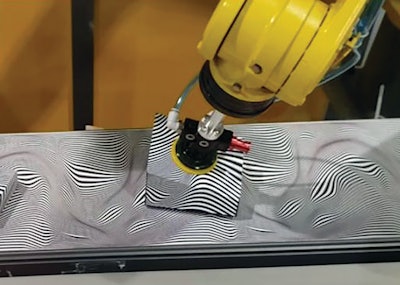 Here, an object painted with a random zebra pattern moves fast on belt painted with the same pattern. The product was camouflaged to the observer, but not to the vision system and accompanying robot.