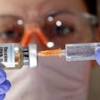 A medical worker prepares a syringe to administer the BioNTech/Pfizer COVID-19 vaccine.