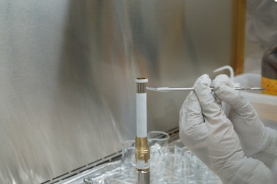 A technician working on the Mars 2020 Perseverance rover mission takes a sample from the surface of sample tube 241 to test for contamination. Each sample tube has its own unique serial number (seen on the gold-colored portion of the tube). The image was taken in a clean room facility at NASA's Jet Propulsion Laboratory in Southern California, where the tubes were developed and assembled.