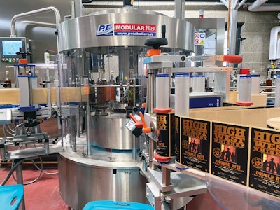 A pressure-sensitive labeler from P.E.Labeller applies either front-and-back or full-wrap labels.