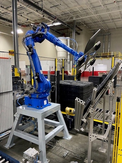 The robot is equipped with a custom-designed EOAT to pick up the heavy plastic lids and wipe down the contents of the bins.