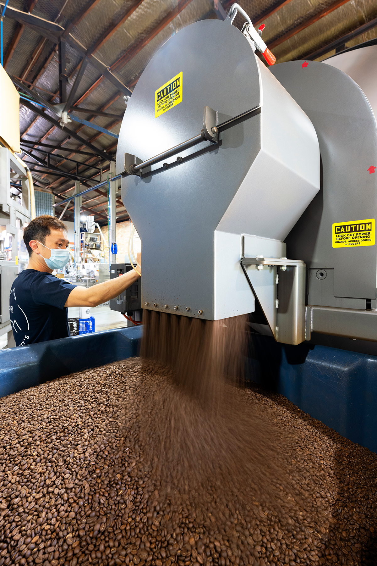 In this rotary batch mixer at Pablo & Rusty’s Coffee Roasters, internal flights direct beans toward and through a stationary discharge as the vessel rotates until fully evacuated.