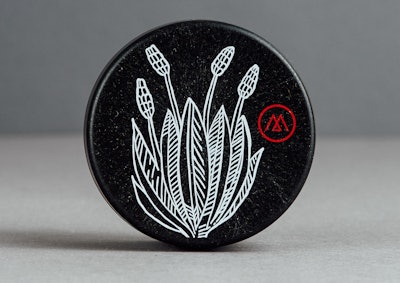 The brand’s logo and a botanical design are screen-printed on the lid of the balm jar.