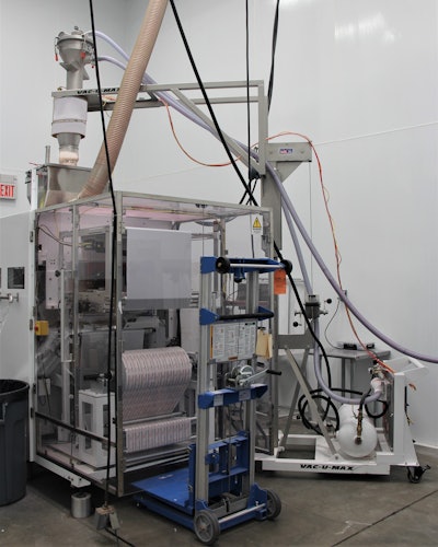 The mobile vacuum conveying system provides continuous supply of material from containers at floor level up and over to refill the stick packaging machine.