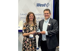 West team member Kate Giannantonio accepts award from INTERPHEX representative on behalf of West