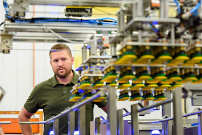 Jordan Hamrick, President, next to a custom dual-robot case packer.